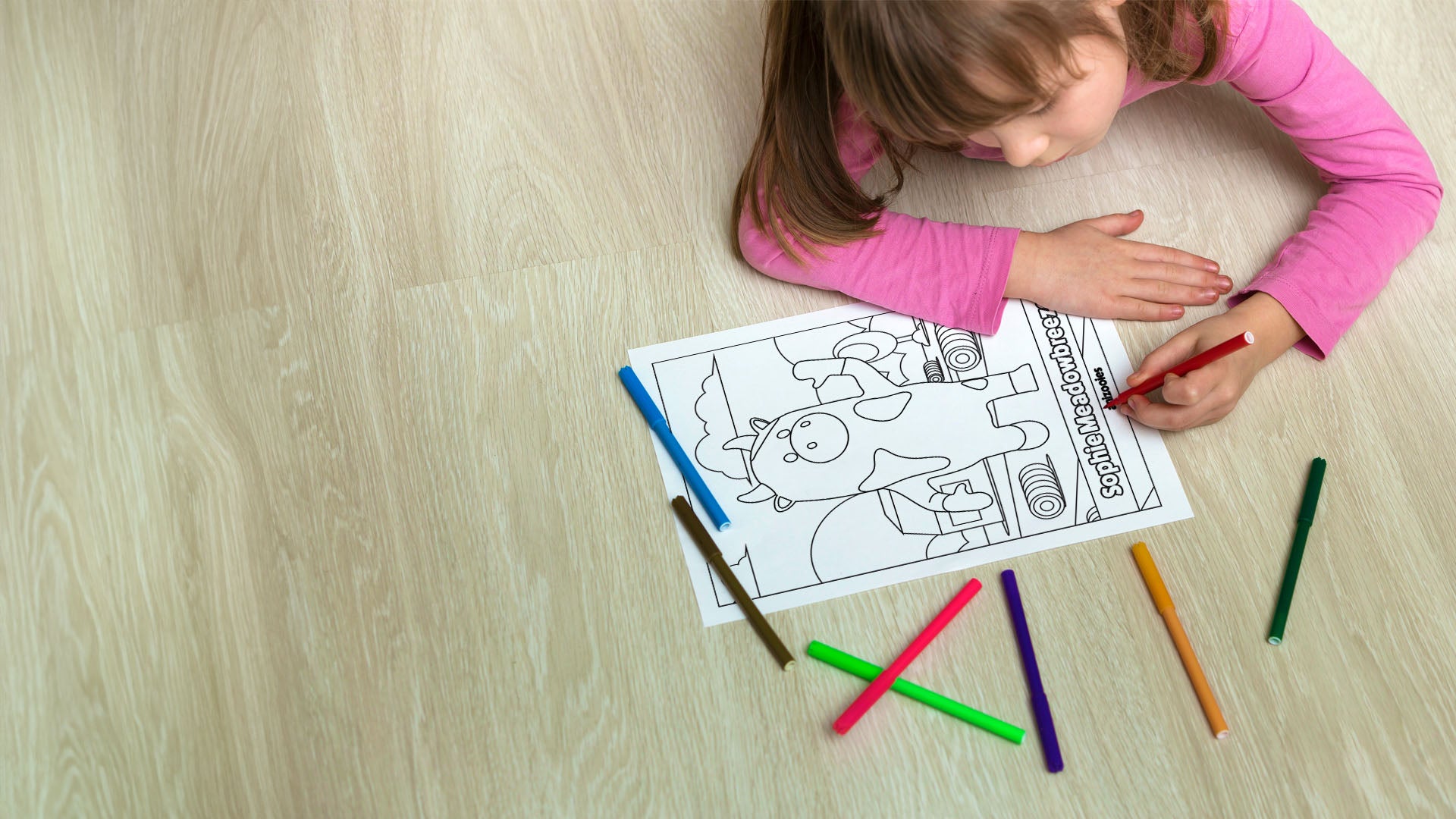 Anizooies Coloring Page Hero Banner featuring a young girl coloring a page with Sophie Meadowbreeze on it.